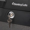 Closeup of keys in the lock of a sentry safe fireproof waterproof box paper digital media device