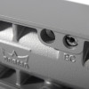 Close up of a silver dorma ts83 overhead door closer back check showing textured metal and screw details