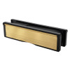 Angled view of a gold 10 inch intumescent letter plate with black edges shown from the side