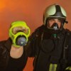 Person wearing a draeger parat 5500 fire escape hood in use alongside another person in protective gear