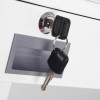 Two black-handled drawer keys inserted in a silver lock on a white drawer front