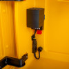 Closeup of the heating light inside the yellow polycarbonate outdoor defibrillator cabinet lock