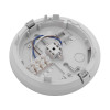 Backplate of a smoke alarm showing internal wiring, a terminal block, and mounting slots on a circular white plastic base.