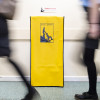 Yellow evacuation dust cover with the evac chair 300h logo shown between two blurred walking figures