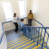 Evac chair 300h evacuation chair being used by two people to move someone on a landing at the top of stairs