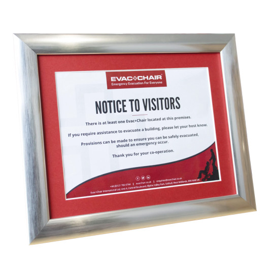 picture frame with notice to visitors about evac chair in a premises