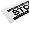 Closeup of sigma smart shield fluorescent stop sticker showing part of the black and white text on a white background