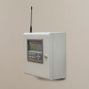 Zerio plus 8 zone control panel mounted on an office wall with buttons and an antenna visible