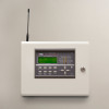 zerio plus 8 zone control panel installed on a beige wall showing buttons and display screen with antenna