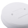 Closeup front view of aico showing a round white surface with embossed text and two screw holes