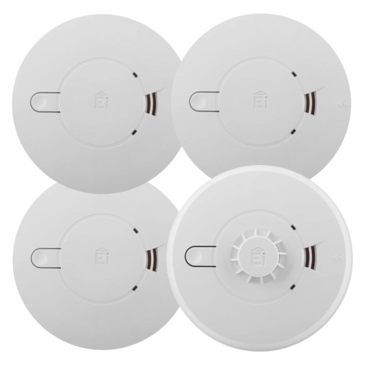 Four Ei-branded circular alarms arranged in a grid, three smoke alarms and one heat alarm with a central sensor.