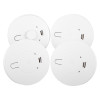 Group of mains powered smoke alarms and heat alarm with alkaline battery backup shown from above