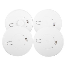 Group of mains powered smoke alarms and heat alarm with alkaline battery backup shown from above