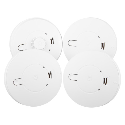 Group of mains powered smoke alarms and heat alarm with alkaline battery backup shown from above