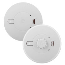 Two round white Aico Ei140e series alarms with simple front panels, one with a smooth finish and one with a vented heat‑sensor grid.