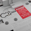Close-up detail of mains rf base showing off and on switch and red warning label about coding radiolink bases