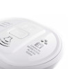 Closeup of an aico carbon monoxide alarm showing the button and part of its sensor grille