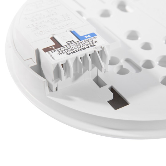 Close-up of the Ei3016 Hard Wire Interlink showing connection terminals and warning labels on a white base