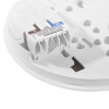 Closeup of the base from an aico mains powered optical smoke alarm with self charging 10 year battery backup