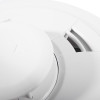 Close-up detail of the aico mains powered combined smoke heat alarm showing its smooth white surface and vents