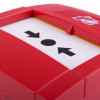 Close up of the button on a wireless manual call point showing arrows pointing towards a central circle