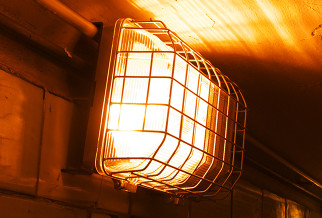 emergency light with vandal cage over the top in a corridor