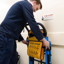 Engineer installing an evacuation chair on a hook