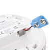 Closeup of the back of a fireangel battery optical smoke alarm showing the battery connector and label with text