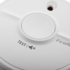 Close-up of the test button on the fireangel battery optical smoke alarm twin pack in white plastic housing