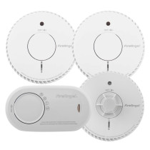 Four FireAngel alarms including two circular smoke alarms and a heat alarm with test/silence buttons and an oval carbon monoxide alarm with multilingual labelling.