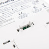 closeup of the back of a fireangel mains powered optical smoke alarm alkaline battery backup showing label and internal components