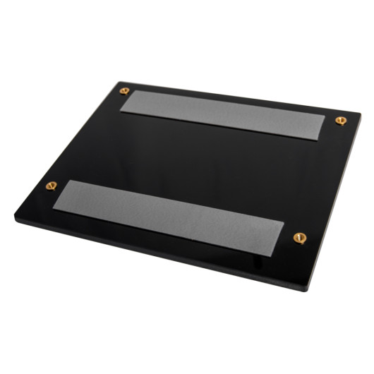 angled view of a dorgard adapter plate for steel door showing a black rectangular plate with two grey strips and four fixing screws