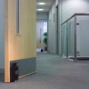 FCDG01 Dorgard Fire Door Retainer Holding a Door Open in a Corridor