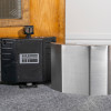dorgard stainless steel cover positioned beside a black dorgard device on a carpeted floor by a wooden door