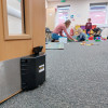 dorgard smartsound door retainer holding a door open with children playing in a room behind it