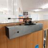 Close up high angle view of the freedor smartsound door closer attached to the top of a wooden door