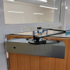 freedor smartsound door closer fixed to the top of a wooden door shown from an angled side view