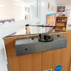 freedor smartsound door closer installed on a wooden door with the arm extended in the open position