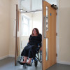 freedor smartsound door closer with wooden double doors open and person in wheelchair passing through