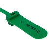 Close up of a single green fire door security tamper seal with printed number C 4476110
