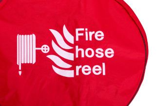 A red fire hose reel cover with a white logo and text