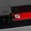 Closeup of a 12v battery fire alarm panel psu showing part of the black casing and metal screw fitting