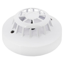 angled close-up of an apollo discovery heat detector showing its round white casing and vented top design