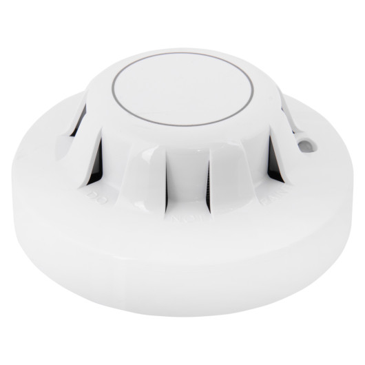 angled view of an apollo xp95 optical smoke detector showing its circular white design with vents around the sides