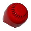 An angled top-down view of a red fire alarm sounder, highlighting the circular vented top section and its glossy plastic surface.