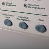 Closeup of grey round buttons labelled Silence Sound Alarm, Alarm Fault Warning Silence, and Reset on kentec sigma cpr 2 zone repeater panel