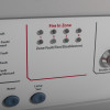 Closeup of indicators and labelled buttons on kentec sigma cpr 4 zone repeater panel showing zone fault test and fire in zone labels