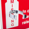 Close up of a shiny metal air horn bracket mounted on a red and white surface with text