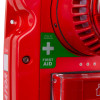 Close-up of the red Fmcsynptg Evacuator Synergy Tough Guard Button showing first aid sign and strobe light vents