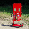 Fmctf7 Fmc Site Trolley with two red powder extinguishers mounted on a red wheeled trolley outdoors